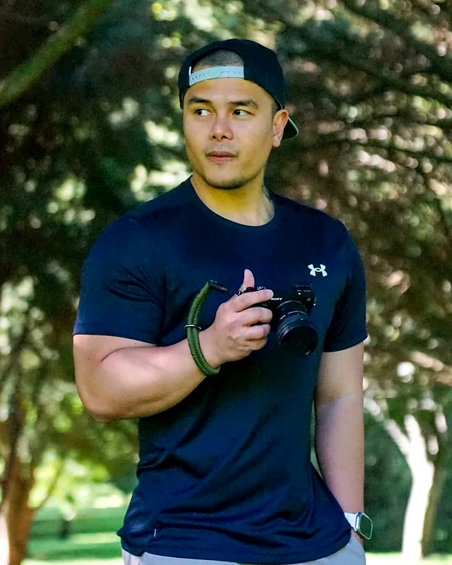 Sherwin holding his camera in a park