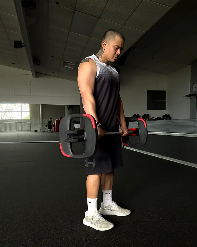 Sherwin lifting a barbell in the group fitness studio