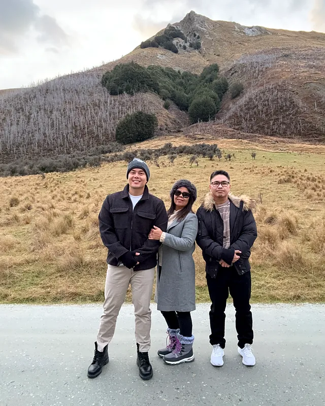 Sherwin with his Mum and Gerald in front of a mountain near Queenstown